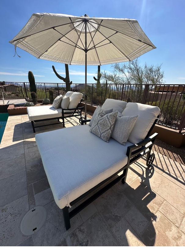 Double chaise lounge with fresh cushions and a desert mountain view
